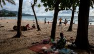 People enjoy at a beach as Phuket opens for foreigners, who are fully vaccinated against the coronavirus disease (COVID-19), to visit the resort island without quarantine, in Phuket, Thailand, September 19, 2021. REUTERS/Athit Perawongmetha//File Photo
