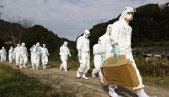 Officials in protective suits head to a poultry farm for a suspected bird flu case in Higashikagawa, western Japan, in this photo taken by Kyodo November 8, 2020. Mandatory credit Kyodo/via REUTERS

