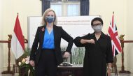 Indonesian Foreign Minister Retno Marsudi bumps elbow with British Foreign Secretary Elizabeth Truss during their meeting in Jakarta, Indonesia, November 11, 2021. Courtesy of Indonesia's Ministry of Foreign Affairs/Handout via Reuters