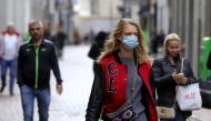 People with and without protective masks walk on the street while shopping as the spread of coronavirus disease (COVID-19) continues in Amsterdam, Netherlands October 7, 2020. REUTERS/Eva Plevier