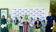 Young golfers pose with their trophies.