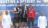 Mohamed Al Rumaihi (centre) and other podium finishers pose with the officials after the medals presentation ceremony at the Lusail Shooting Complex, yesterday. 