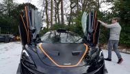 FILE PHOTO: Steve Glynn, who has owned a number of McLarens and says he is willing to try out electric models when they become available, displays his most recently acquired McLaren at his home in Headley Down, Britain February 11, 2021 REUTERS/Nick Carey
