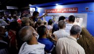 People wait to receive a dose of the coronavirus disease (COVID-19) vaccine at an immediate vaccination center operating at the Sadat underground metro station, in Cairo, Egypt, November 14, 2021. REUTERS/Mohamed Abd El Ghany