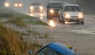 A car lies submerged in a ditch on a flooded stretch of road after rainstorms lashed the western Canadian province of British Columbia, triggering landslides and floods, shutting highways, in Chilliwack, British Columbia, Canada November 15, 2021. REUTERS/Jennifer Gauthier