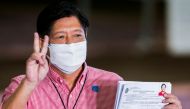 Ferdinand Marcos Jr, the son of late Philippines dictator Ferdinand Marcos, poses for pictures after filing his certificate of candidacy for president in the 2022 national election, in Pasay City, Metro Manila, Philippines, October 6, 2021. Rouelle Umali/Pool via Reuters/File Photo