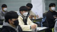 Students wait to take the annual College Scholastic Ability Test (CSAT), a nationwide university entrance exam, amid coronavirus disease (COVID-19) outbreak, at a school in Seoul, South Korea November 18, 2021. Jung Yeon-je/Pool via REUTERS