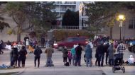 A red SUV speeds past attendees moments before plowing into a crowd at a Christmas parade in Waukesha, Wisconsin, U.S., in this still image taken from a November 21, 2021 social media video. CITY OF WAUKESHA/Facebook/via REUTERS