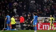 Olympique de Marseille's Matteo Guendouzi reacts after Dimitri Payet goes down after being hit by a water bottle thrown by a fan leading to the game being interrupted REUTERS/Benoit Tessier