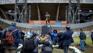 Fans of Argentinean soccer legend, Diego Armando Maradona, take photos during the unveiling ceremony of his statue in front of the stadium, on the first anniversary of his death, in Naples, Italy, November 25, 2021. REUTERS/Ciro De Luca
