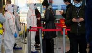 Security guards block an exit as they directs people to scan a QR code to track their health status at Shanghai Hongqiao Railway Station, following new cases of the coronavirus disease (COVID-19), in Shanghai, China, November 25, 2021. Picture taken November 25, 2021. REUTERS/Aly Song
 