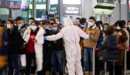 A security guard blocks an exit as he directs people to scan a QR code to track their health status at Shanghai Hongqiao Railway Station, following new cases of the coronavirus disease (COVID-19), in Shanghai, China, November 25, 2021. Picture taken November 25, 2021. REUTERS/Aly Song