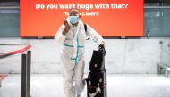 A traveller wearing personal protective equipment arrives at the international terminal at Sydney Airport, as countries react to the new Omicron variant of the coronavirus, in Sydney, Australia, November 29, 2021. AAP Image/James Gourley via REUTERS