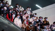 People wearing protective masks are seen inside a subway station, following new cases of the coronavirus disease (COVID-19), in Shanghai, China, November 30, 2021. REUTERS/Aly Song
 