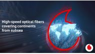 A 3D image concept of global communication shows optical fibers lit in the shape of the world map.