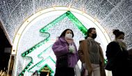 Women wearing masks to prevent contracting the coronavirus disease (COVID-19) walk under a Christmas illumination at a shopping district in central Seoul, South Korea, December 1, 2021. REUTERS/Kim Hong-Ji/File Photo