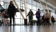 People walk inside Schiphol Airport after Dutch health authorities said that 61 people who arrived in Amsterdam on flights from South Africa tested positive for COVID-19, in Amsterdam, Netherlands, November 27, 2021. REUTERS/Eva Plevier
