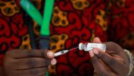 A health worker takes a dose of the coronavirus disease (COVID-19) vaccine from a vial during the roll out of mass vaccination for the disease in Abuja, Nigeria, November 19, 2021. REUTERS/Afolabi Sotunde