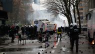 Police officers walk on the street during a protest against the Belgian government's restrictions imposed to contain the spread of the coronavirus disease (COVID-19), in Brussels, Belgium December 5, 2021. REUTERS/Johanna Geron
