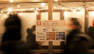 People queue to enter a Christmas market open only for visitors who are vaccinated or recovered from the coronavirus disease (COVID-19) at the red-light district 