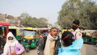 A healthcare worker collects a coronavirus disease (COVID-19) test swab sample from a man on a road in New Delhi, India, December 6, 2021. REUTERS/Anushree Fadnavis