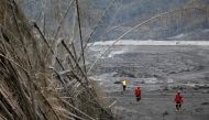 Rescue workers search an area in the aftermath of the eruption of Mount Semeru volcano, in Curah Kobokan, Indonesia December 7, 2021. REUTERS/Willy Kurniawan