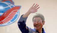 Japanese entrepreneur and space flight participant Yusaku Maezawa waves behind a glass wall during a news conference in Baikonur, Kazakhstan December 7, 2021. REUTERS/Shamil Zhumatov/Pool