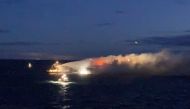 Firefighting boats work as timber cargo burns on the Liberian-flagged Almirante Storni bulk carrier, off Gothenburg, Sweden December 4, 2021 in this image obtained from social media. Picture taken December 4, 2021. Mikael Holst Mattsson via REUTERS/Files

