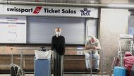 Passengers wait for confirmation of flights outside the Swissport Ticket Sales counter as several airlines stopped flying out of South Africa, amidst the spread of the new SARS-CoV-2 variant Omicron, at O.R. Tambo International Airport in Johannesburg, South Africa, November 28, 2021. REUTERS/ Sumaya Hisham/File Photo



