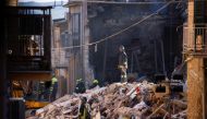 Rescuers work at the site of a gas explosion that caused several houses to collapse in Ravanusa, Italy, December 13, 2021. REUTERS/Guglielmo Mangiapane
 