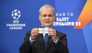UEFA Deputy General Secretary Giorgio Marchetti draws out the card of Paris St Germain during the UEFA Champions League 2021/22 Round of 16 Draw at the UEFA headquarters (UEFA/Handout via REUTERS)