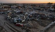 :A man walks past destroyed residences and businesses in the aftermath of a tornado in the city center of Mayfield, Kentucky, U.S. December 13, 2021. Picture taken with a drone. REUTERS/Adrees Latif
