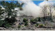 A still image from a social media video shows dust disturbances on side of hill after an earthquake in Nagekeo, East Nusa Tenggara, Indonesia December 14, 2021. Alldo Van Robby/via REUTERS