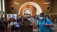 A traveller wearing a protective mask walks past a waiting area for Amtrak customers inside Union Station in downtown Los Angeles, California, U.S., August 21, 2021. REUTERS/Bing Guan/File Photo