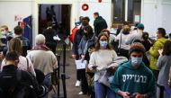 People queue at a coronavirus disease (COVID-19) vaccination centre in London, Britain, December 15, 2021. REUTERS/Hannah McKay
