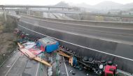 Overturned vehicles are seen at the site where a highway flyover collapsed in Ezhou, Hubei province, China December 19, 2021. Picture taken with a drone. REUTERS.