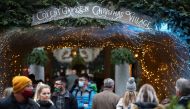 People visit the Covent Garden Christmas Village, in London, Britain, December 20, 2021. REUTERS/Hannah McKay
