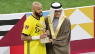 Asian Football Federation President Shaikh Salman bin Ebrahim Al Khalifa presents the golden glove to Algeria’s Rais Mbolhi after the final of the FIFA Arab Cup Qatar 2021 on Saturday.