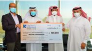 Ahmed Al Hanzab (second right), Head of Administration & Property Department at Doha Bank, presenting the bank’s donation to Qatar Red Crescent officials. 