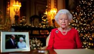 Britain's Queen Elizabeth records her annual Christmas broadcast in the White Drawing Room in Windsor Castle, next to a photograph of the queen and the Duke of Edinburgh, in Windsor, Britain, December 23, 2021. Victoria Jones/Pool via REUTERS

