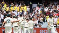 Mitchell Starc of Australia celebrates with teammates after dismissing Joe Root of England in the third Ashes test at Melbourne Cricket Ground in Melbourne, Australia, December 26, 2021. Reuters/Loren Elliott
