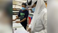 An inspector from Doha Municipality checking a food outlet.