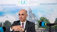 FILE PHOTO: Swiss Interior Minister Alain Berset cleans his hands before a news conference on the coronavirus disease (COVID-19) outbreak, after meeting with the HUG's medical staff and visiting the emergency department, at the Geneva University Hospitals (HUG), in Geneva, Switzerland, March 24, 2020. Salvatore Di Nolfi/Pool via REUTERS/File Photo
