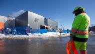 A worker monitors traffic around a new extension of the National Research Council of Canada building under construction, in Montreal, Quebec, Canada February 4, 2021. REUTERS/Christinne Muschi

