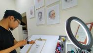 Arsenio Jr Nidoy scribbling a portrait in his studio