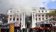 File photo: Firefighters work after a fire broke out in the Parliament in Cape Town, South Africa, January 2, 2022. Elmond Jiyane/GCIS/Handout via Reuters