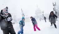 Will Modi, left, reacts after being hit by a snowball by Nicole D'ercole , right, during a snow storm on Capitol Hill in Washington, U.S., January 3, 2022. REUTERS/Tom Brenner
