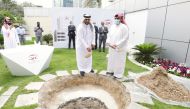 Salem Al Mannai (second right front), Group CEO of QIC Group, buries the ‘Time Capsule’, while other officials look on, at a function, in Doha, recently.