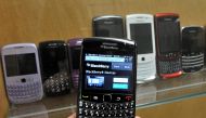 A BlackBerry device is shown in front of products displayed in a glass cabinet at the Research in Motion offices in Waterloo November 14, 2012. REUTERS/Mike Cassese/File Photo