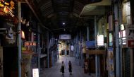 Passersby wearing protective face masks, amid the coronavirus disease (COVID-19) pandemic, walk at a shopping arcade in the prefectural capital Naha, on the southern island of Okinawa, Okinawa prefecture, Japan, October 24, 2021. Picture taken October 24, 2021. REUTERS/Issei Kato

